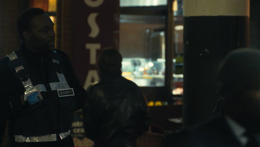 Terence stands guard in the high street at night